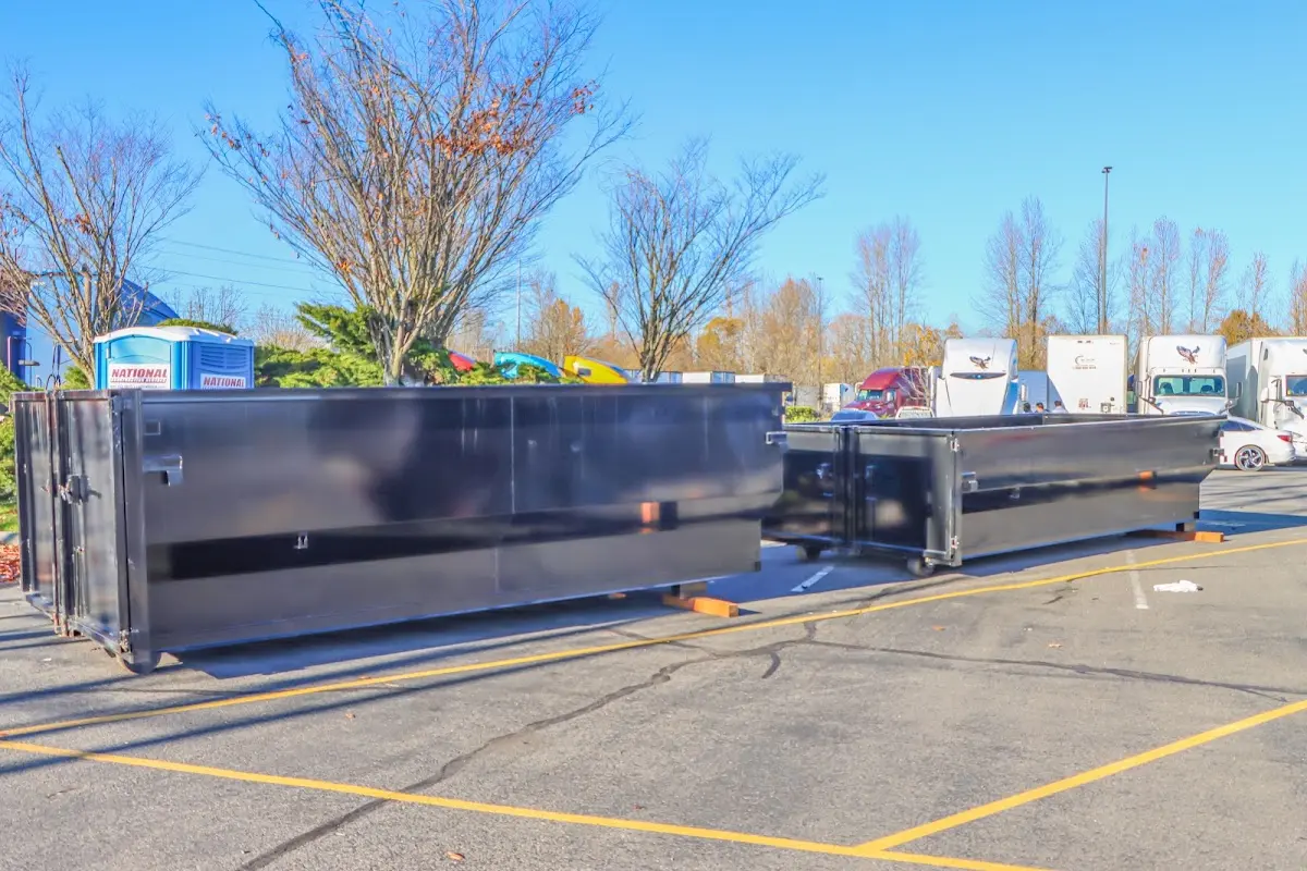 Professional dumpster rental service with roll-off container on residential driveway in Sherman